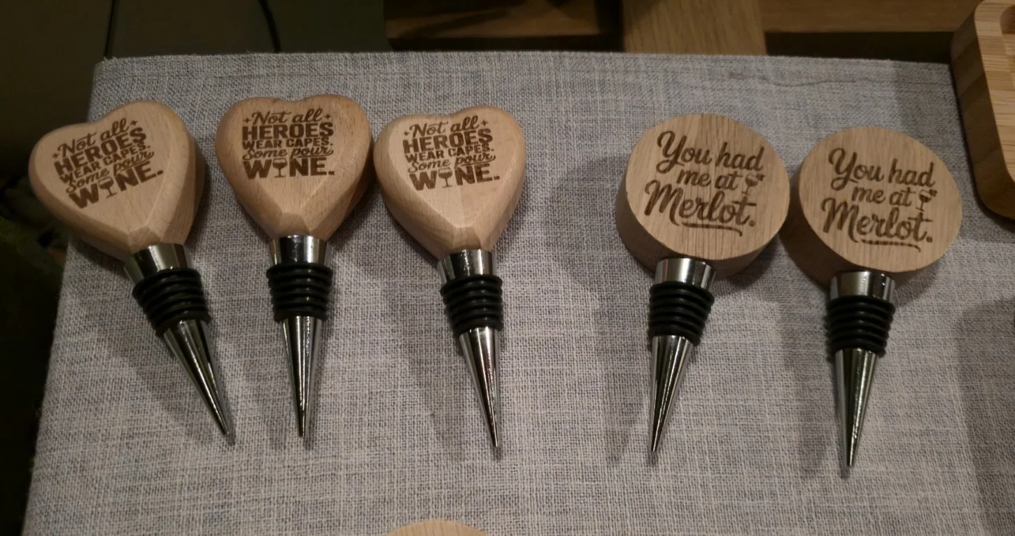 Wooden wine bottle stoppers featuring engraved messages