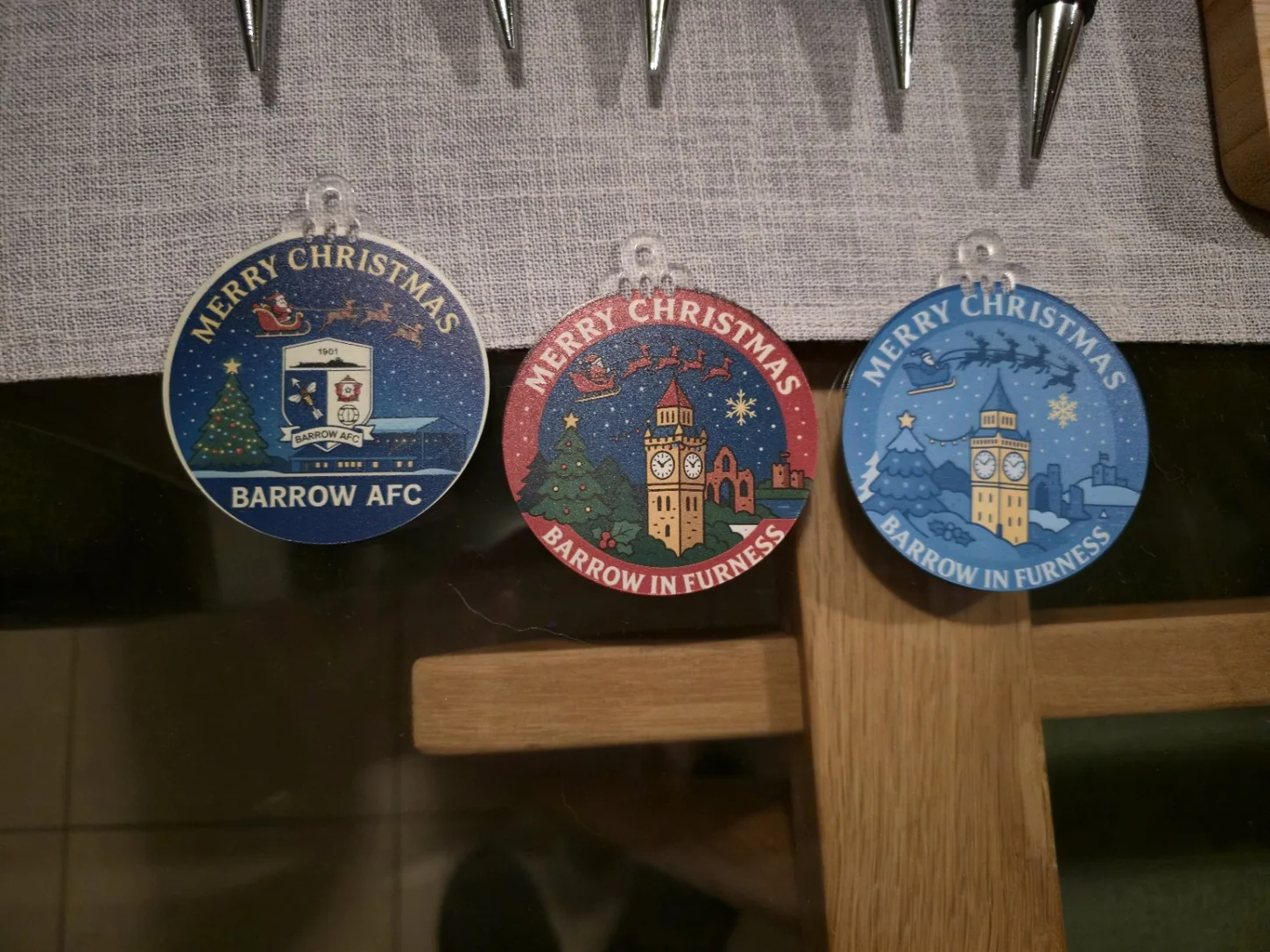 Three colour-printed Christmas decorations with Barrow AFC and town designs